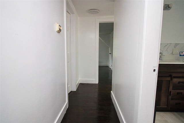 hallway featuring dark hardwood / wood-style flooring