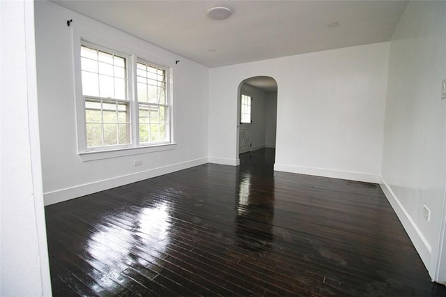 empty room featuring dark wood-type flooring