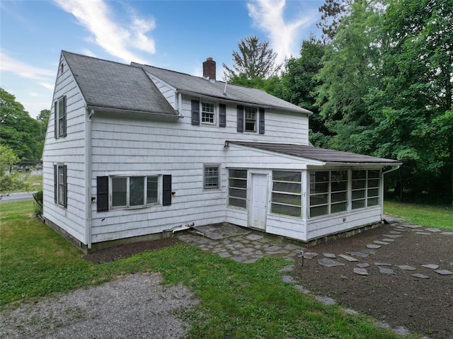 rear view of house with a sunroom