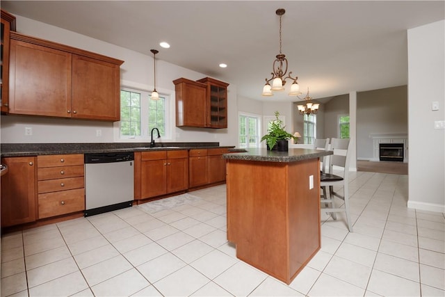 kitchen featuring dishwasher, a center island, sink, decorative light fixtures, and a chandelier