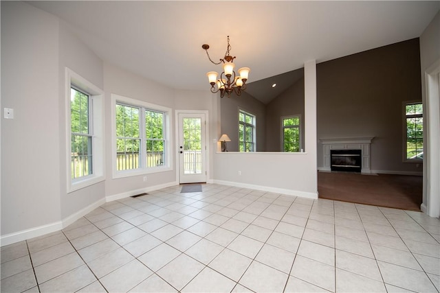 unfurnished living room featuring light tile patterned flooring, a chandelier, and lofted ceiling