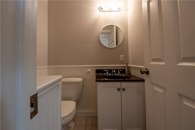 bathroom featuring tile patterned flooring, vanity, and toilet