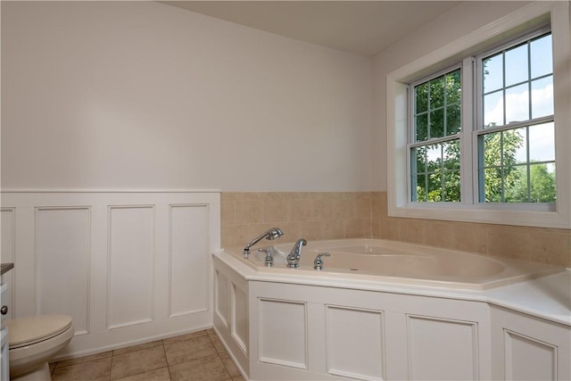 bathroom with tile patterned floors, a bathtub, and toilet