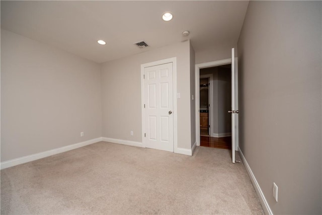 unfurnished bedroom featuring light carpet