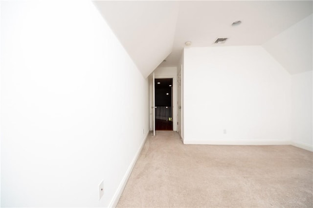 bonus room with light carpet and lofted ceiling