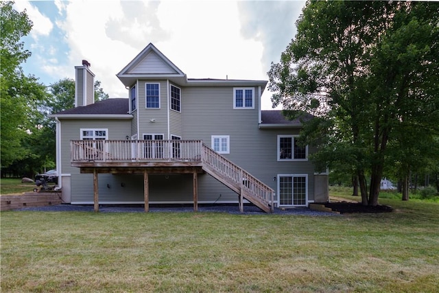 rear view of house with a yard and a wooden deck