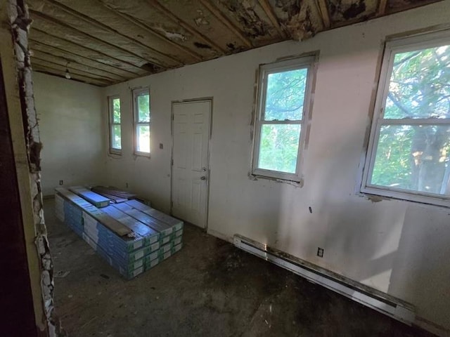 misc room featuring a baseboard radiator and a healthy amount of sunlight