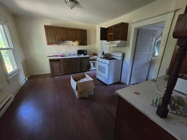 kitchen featuring sink, dark hardwood / wood-style flooring, baseboard heating, and gas range gas stove