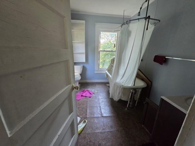 bathroom featuring a shower with shower curtain and toilet