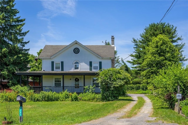 farmhouse with a front lawn and covered porch