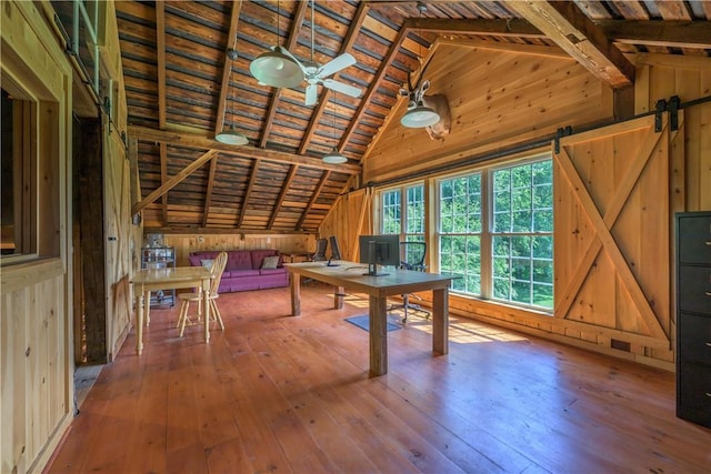 unfurnished office with hardwood / wood-style flooring, lofted ceiling with beams, wood walls, and wood ceiling