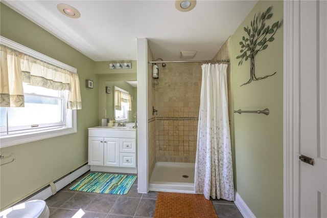 bathroom with a shower with shower curtain, vanity, baseboard heating, tile patterned flooring, and toilet