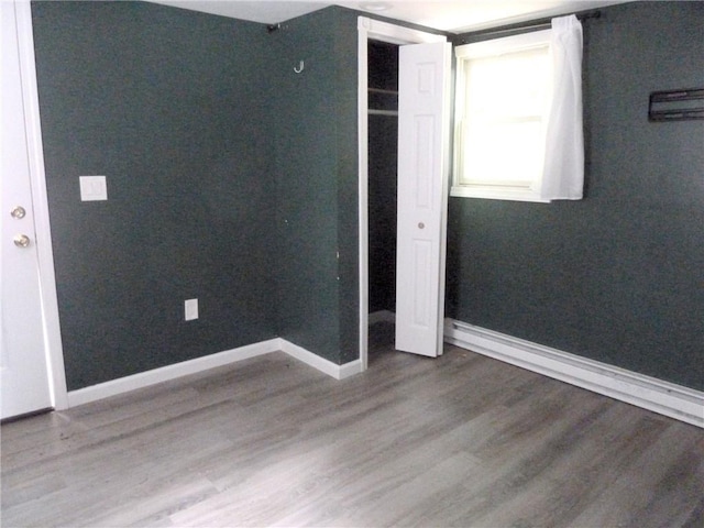 unfurnished bedroom with wood-type flooring and a closet