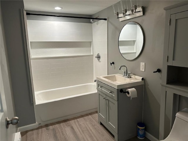 full bathroom featuring vanity, hardwood / wood-style floors, shower / bathing tub combination, and toilet