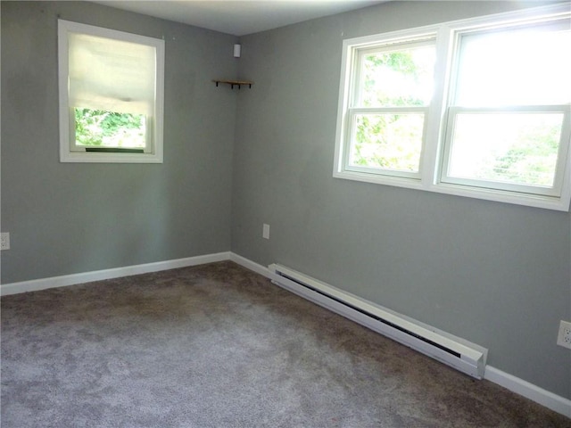 unfurnished room featuring carpet flooring and a baseboard heating unit