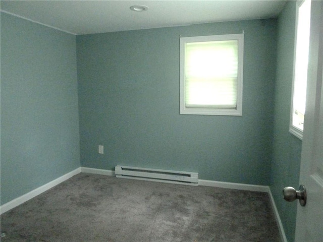 carpeted empty room with a baseboard radiator