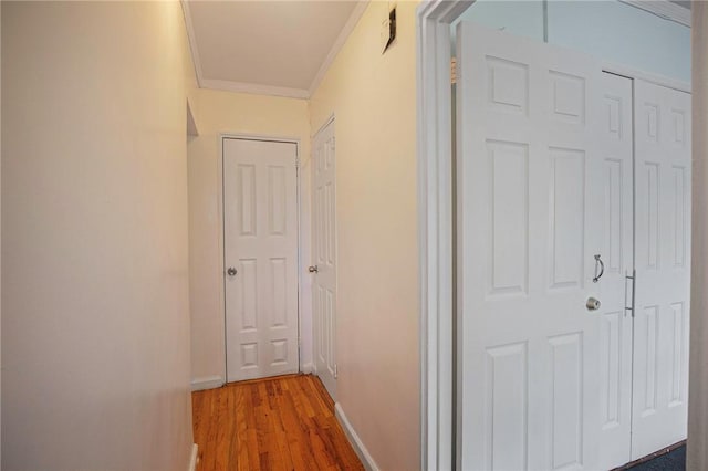 corridor with crown molding and wood-type flooring