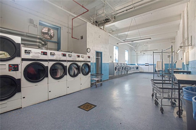 laundry room with stacked washer and clothes dryer and washing machine and clothes dryer