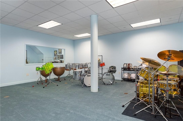 miscellaneous room with dark colored carpet and a drop ceiling