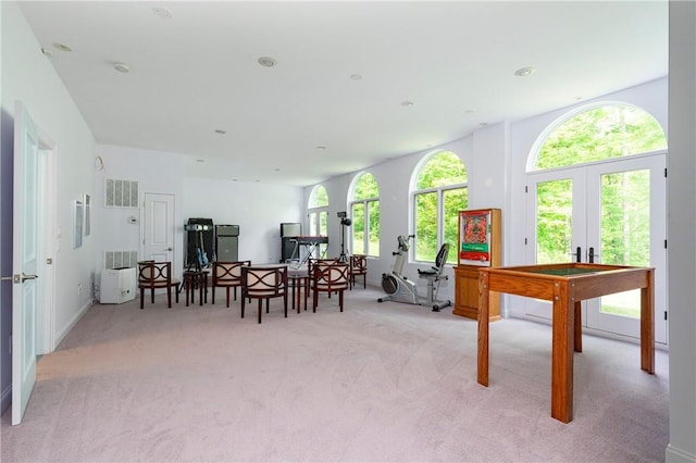 game room with light carpet and french doors