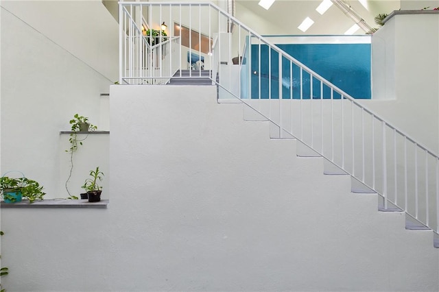 staircase featuring a towering ceiling