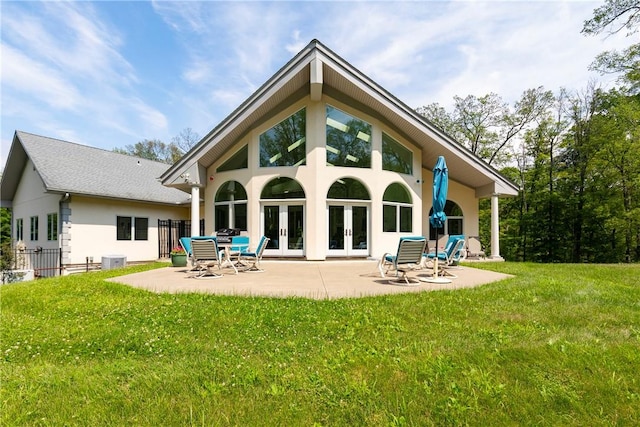 back of property featuring a lawn, a patio area, central air condition unit, and french doors