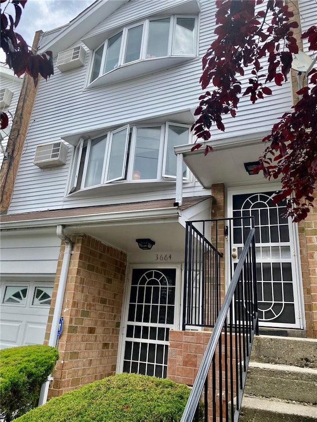 view of exterior entry featuring a wall mounted air conditioner