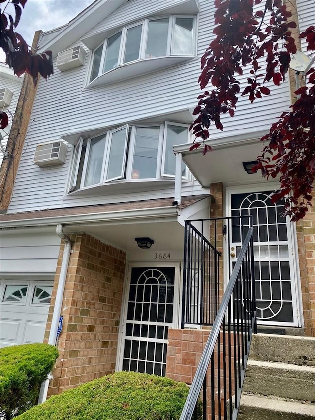3664 Palmer Ave, Bronx, NY 10466 - property entrance with brick siding and a wall mounted air conditioner