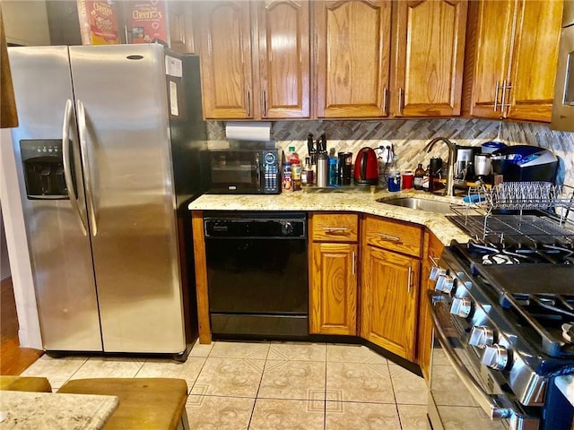 3664 Palmer Ave, Bronx, NY 10466 - kitchen with stainless steel appliances, brown cabinets, light tile patterned flooring, light stone counters, and backsplash