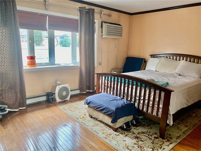 bedroom with hardwood / wood-style flooring, a wall mounted air conditioner, crown molding, and a baseboard radiator