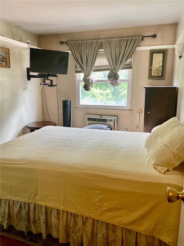 bedroom featuring an AC wall unit