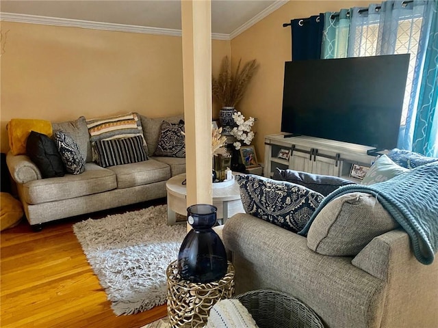 living room featuring wood-type flooring and ornamental molding