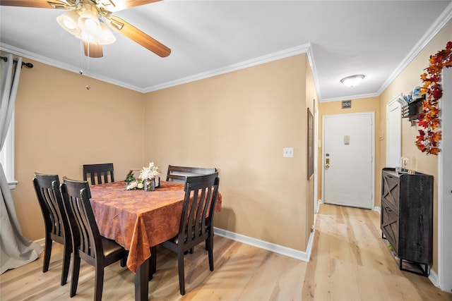 dining space featuring ceiling fan, light hardwood / wood-style flooring, and ornamental molding