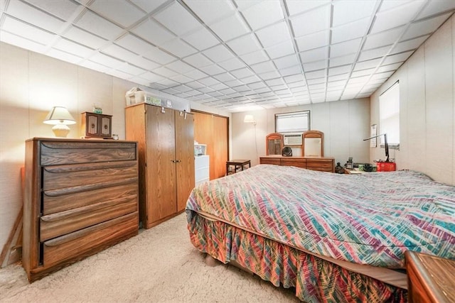 carpeted bedroom with a drop ceiling