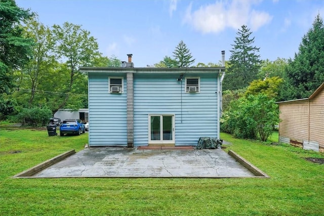 rear view of property with cooling unit, a patio area, and a lawn