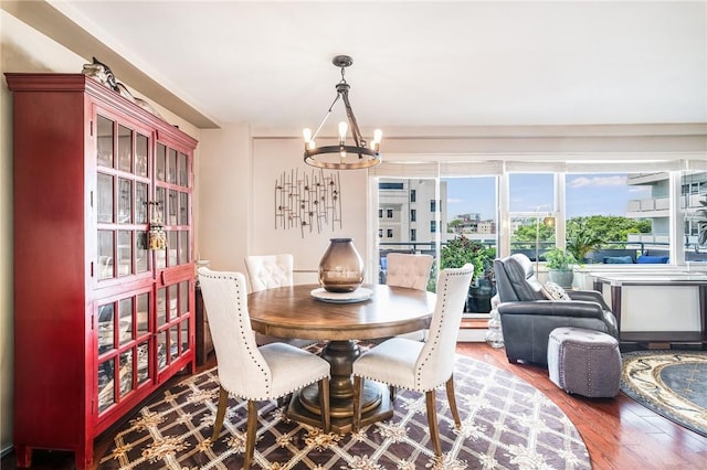 dining area featuring a notable chandelier and hardwood / wood-style flooring