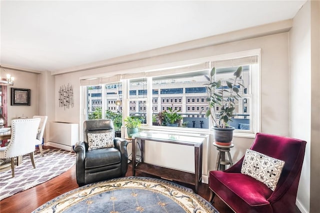 living area with a notable chandelier and hardwood / wood-style flooring