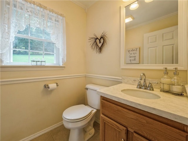 bathroom with toilet, tile patterned flooring, crown molding, and vanity