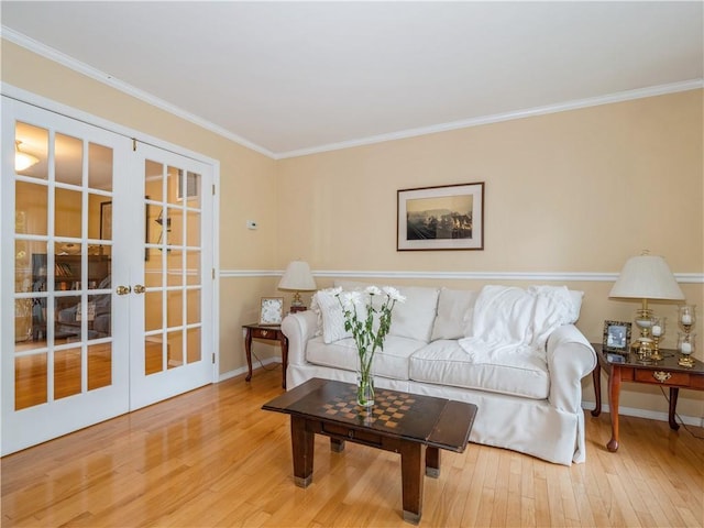 living area featuring french doors, crown molding, baseboards, and wood finished floors