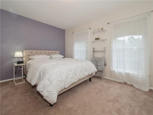 bedroom featuring carpet floors and baseboards