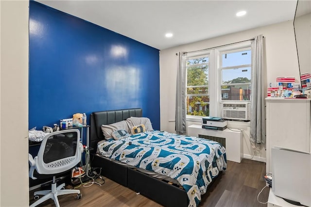 bedroom featuring cooling unit and dark wood-type flooring