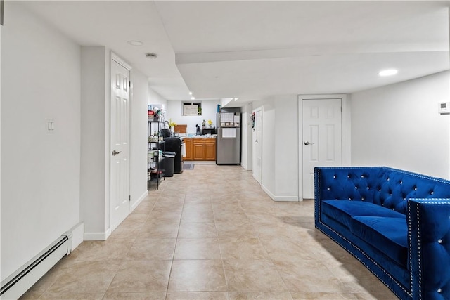 corridor with light tile patterned floors and baseboard heating