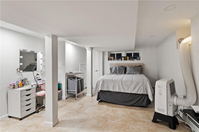 bedroom with light tile patterned floors and a baseboard radiator