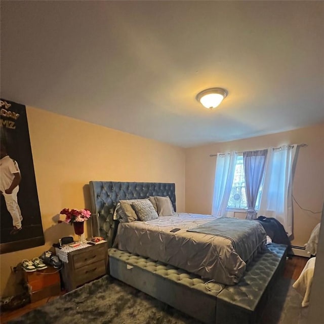 bedroom featuring dark wood-type flooring and a baseboard radiator