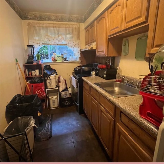 kitchen with black range with electric stovetop, sink, and dark tile patterned floors