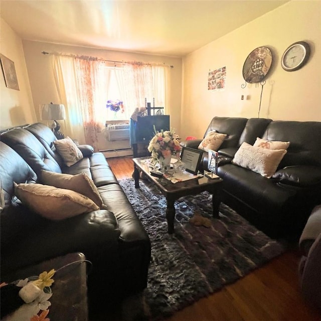 living room featuring wood-type flooring and a baseboard heating unit