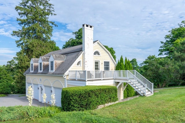 20 Smithfield Way, Amenia, NY 12501 - back of house featuring a lawn, driveway, stairway, a garage, and a chimney