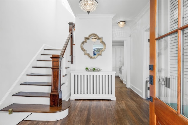 entryway featuring baseboards, stairway, ornamental molding, wood finished floors, and a chandelier