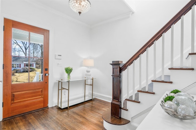 entryway with stairway, baseboards, ornamental molding, and wood finished floors