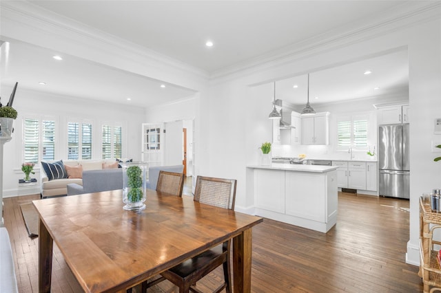 dining area featuring baseboards, ornamental molding, dark wood-style flooring, and recessed lighting